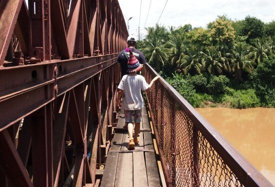 Old bridge crossing over river luang prabang