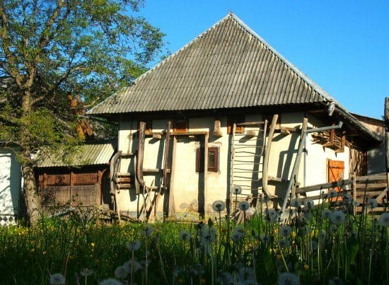 Sledges wait for winter snows on the side of the barn in a Romanian village.