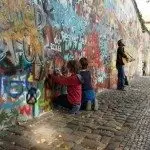 London to Romania by Car Driving accross Europe, drawing on the Lennon wall in Prague