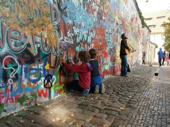 London to Romania by car. One of the highlights of Prague on our child-focussed city tour. Art at the Lennon wall as a busker played Imagine.