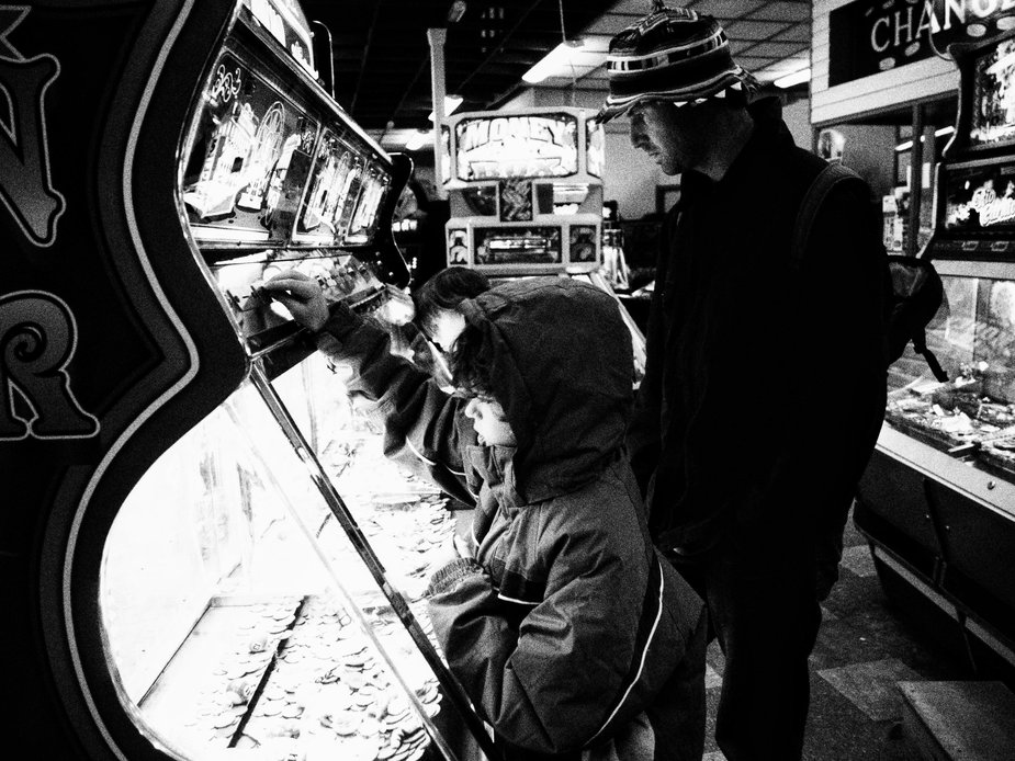Child enjoying Amusements, penny arcade in Wales.Wales Travel Blog South Wales seaside town