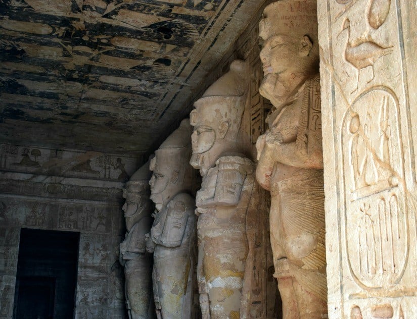 Abu Simbel statues of Rameses. Photograph of inside temple. Rameses statue is lit at dawn.