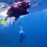 SWIM WITH MANTA RAYS IN BALI family snorkelling in deep blue water to see manta rays off bali