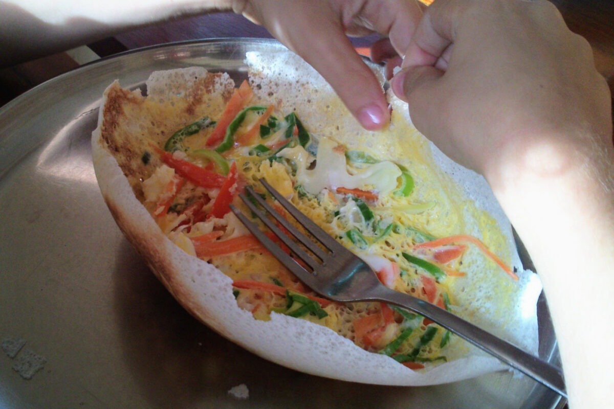 hopper filled with egg and vegetables, child eating.