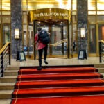 Was It Worth Staying At The Fullerton Hotel in Singapore? Fullerton hotel entrance steps, my son and his backpack.