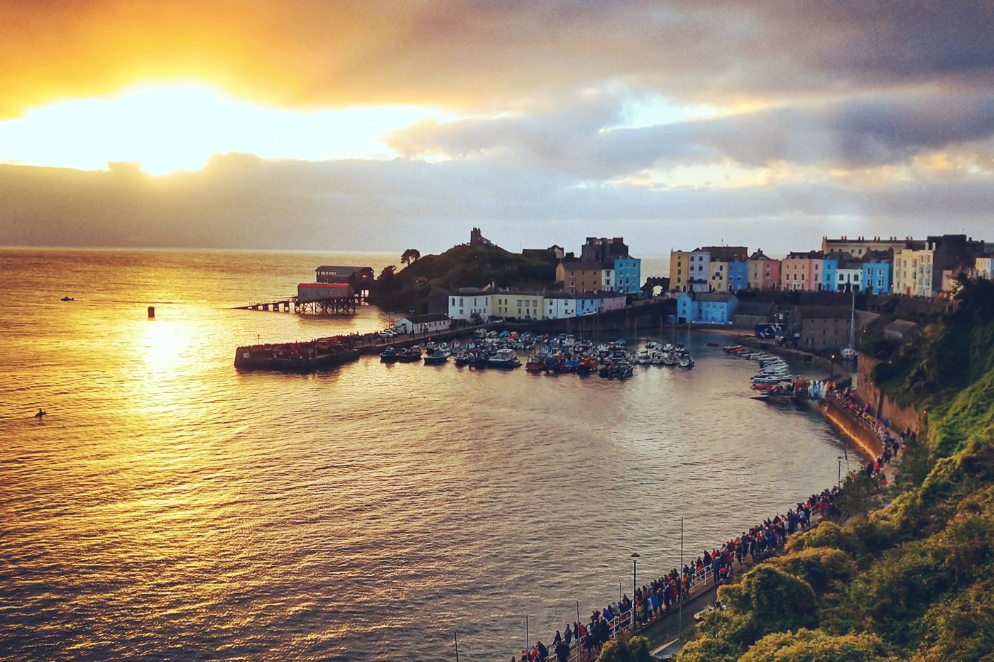 Beautiful fishing harbour, old buildings and beach at dawn Tenby, Wales