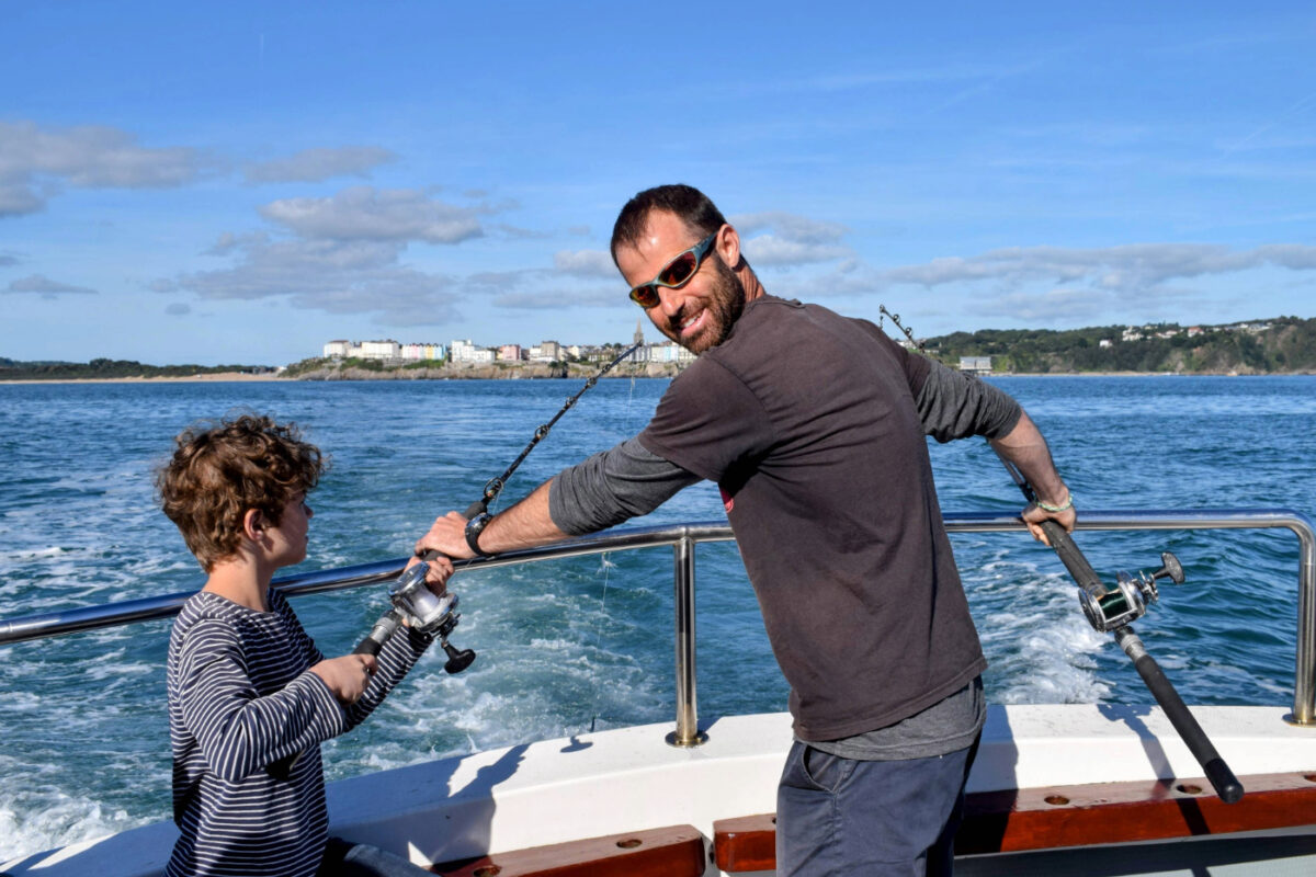 Family fishing from a boat off south wales for mackerel