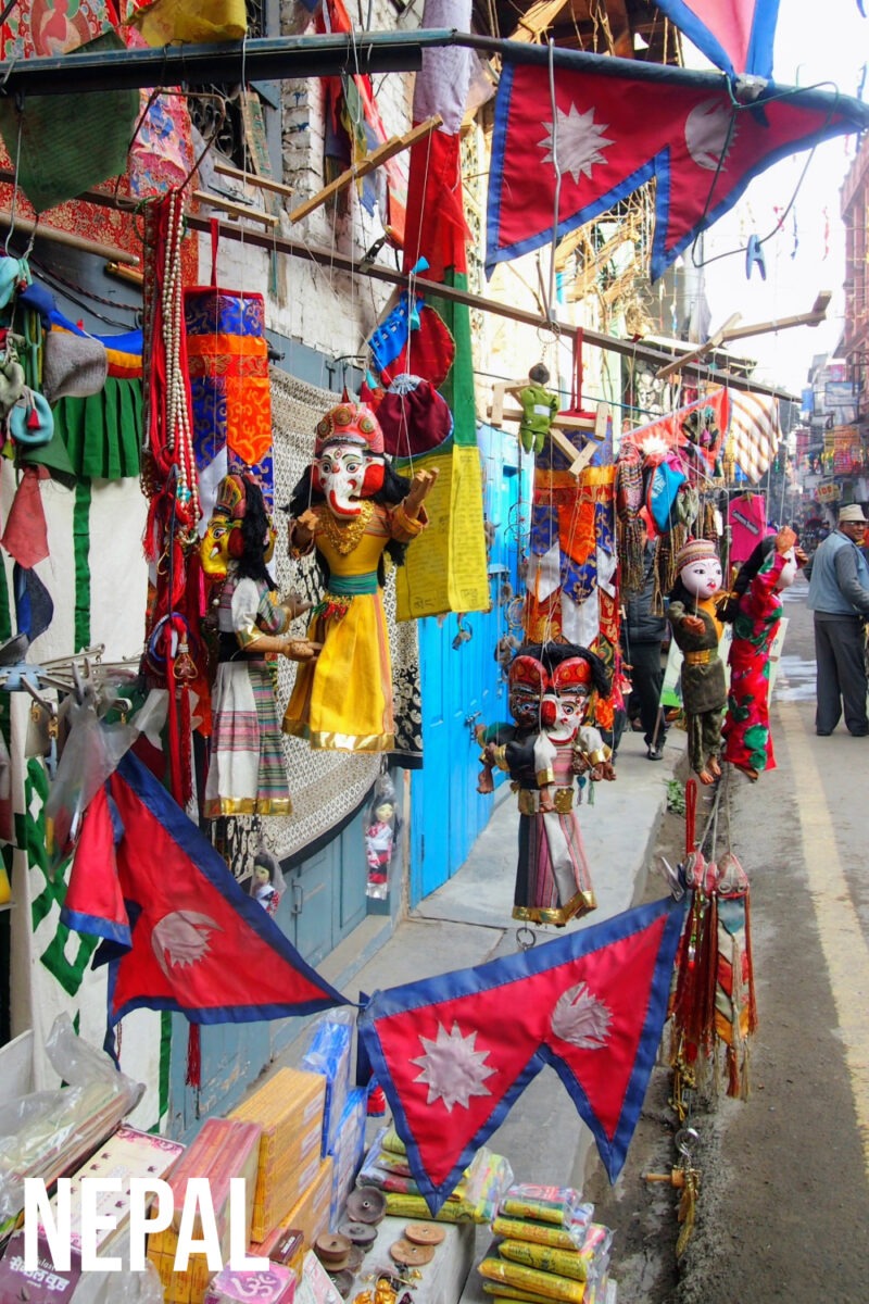 The Nelali flag, traditional puppets and prayer flags at a small shop near Thamel Nepal