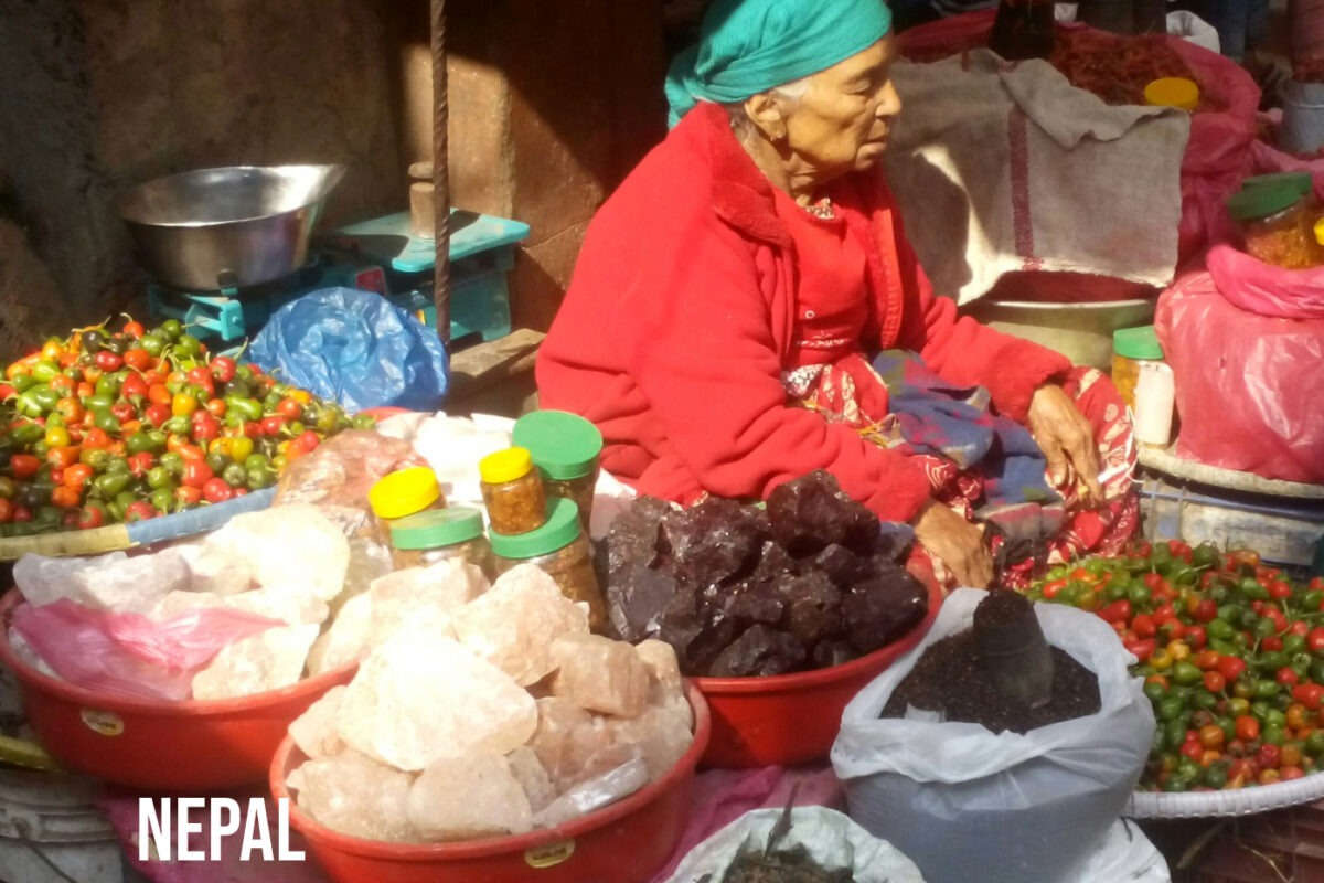 Market stall in Nepal, pink Himalayan sea salt, chillies and pepper.