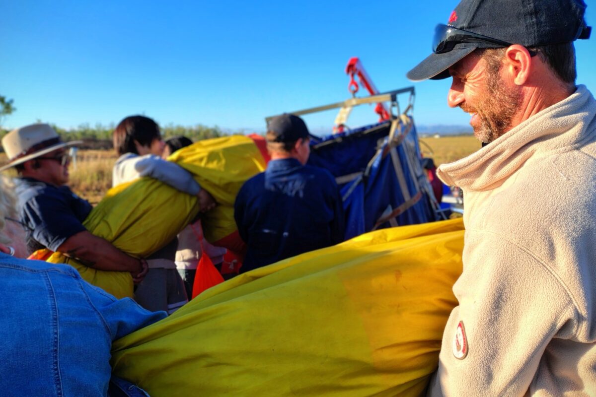 Folding hot air balloon back into the bag.